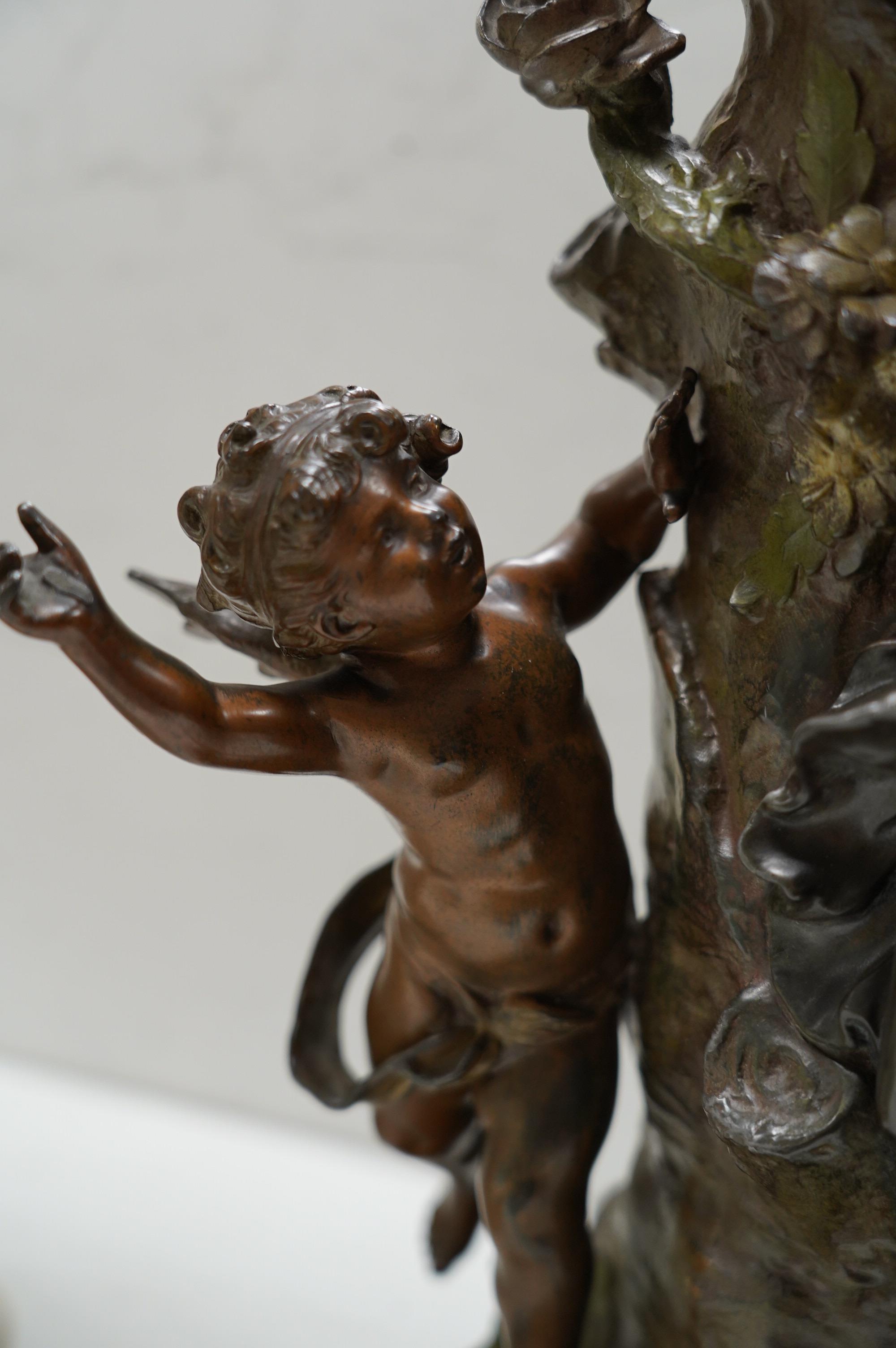 A French Art Nouveau spelter patinated figural table clock, ‘Jardin D’Amour’, with a late 19th century movement striking on a bell, height 53cm. Condition - good